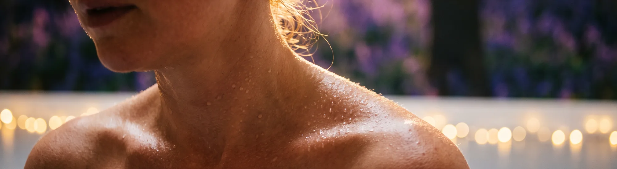 Close-up of sweat beading on a shoulder in warm light.